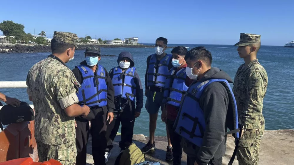 This government handout photo shows five shipwrecked fishermen wearing lifejackets, who were rescued by an Ecuadorian tuna fishing boat after being adrift for more than 50 days, at the San Cristobal Naval Base, Galapagos Islands, Ecuador, Saturday, May 10, 2025. (Ecuadorean Navy via AP)