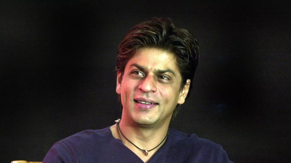 ** FILE ** Bollywood actor Shah Rukh Khan smiles during the launch of the "confidence plan" for hearing impaired by an Indian cellular company in Bombay, India, in this May 20, 2004 file photo. Bollywood leading man Shah Rukh Khan says he felt uncomfortable taking on the role of a husband who leaves his wife and child for another woman in his latest film. (AP Photo / Aijaz Rahi, file)