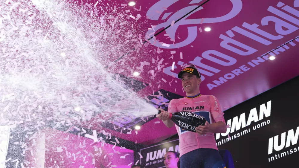 Denmark's Mads Pedersen, in the pink jersey, celebrates winning the fifth stage of the Giro d'Italia cycling race from Ceglie Messapica to Matera, Italy, Wednesday, May 14, 2025. (Gianmattia D'Alberto/LaPresse via AP)