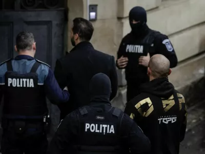 Tristan Tate and Andrew Tate are brought in by police officers to appear in front of a judge at the Bucharest Court of Appeal, in Bucharest, Romania, March 12, 2024. Inquam Photos/Octav Ganea via REUTERS ATTENTION EDITORS - THIS IMAGE WAS PROVIDED BY A THIRD PARTY. ROMANIA OUT. NO COMMERCIAL OR EDITORIAL SALES IN ROMANIA