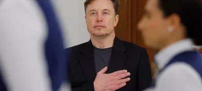Tesla CEO Elon Musk holds his hand on his heart as the U.S. national anthem is played at a state dinner hosted by Qatar's Emir Tamim bin Hamad Al Thani during a visit by U.S. President Donald Trump, at Lusail Palace in Lusail, Qatar, May 14, 2025. REUTERS/Brian Snyder