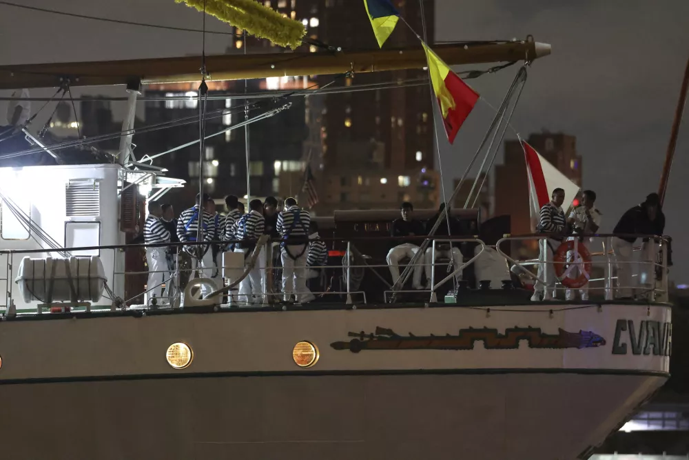Crew members aboard the Cuauht&eacute;moc, a masted Mexican Navy training ship, gather on deck after the ship collided with the Brooklyn Bridge, Saturday, May 17, 2025, in New York. (AP Photo/Yuki Iwamura)