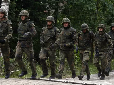 Bundeswehr German armed forces 701 tank battalion run during an exercise at a training area in Grafenwoehr near the southern German town of Nuremberg, August 24, 2010. The 701 tank battalion exercise a bridge building with U.S. army soldiers during their preparation for their deployment as ISAF troops to Afghanistan.   REUTERS/Fabrizio Bensch (GERMANY - Tags: POLITICS MILITARY)