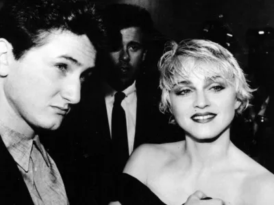 Sean Penn and his wife, singer Madonna, stop April 17, 1986 to chat with reporters prior to the screening of Penn's new movie "At Close Range" in Los Angeles. (AP photo/Craig Mathew)