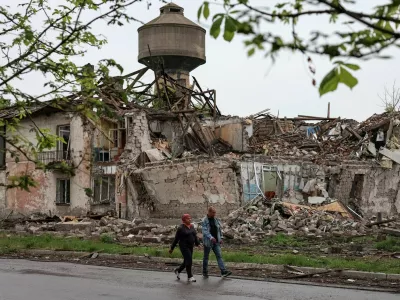 Residents walk at a street near buildings damaged by Russian military strikes, amid Russia's attack on Ukraine, in the frontline town of Myrnohrad, Donetsk region, Ukraine May 29, 2025. REUTERS/Anatolii Stepanov / Foto: Anatolii Stepanov