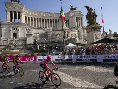 Primoz Roglic of Slovenia wears the overall leader's pink jersey as he rides past the Unknown Soldier monument during the 21st and last stage of the Giro D'Italia, tour of Italy cycling race, in Sunday, May 28, 2023. (AP Photo/Alessandra Tarantino)