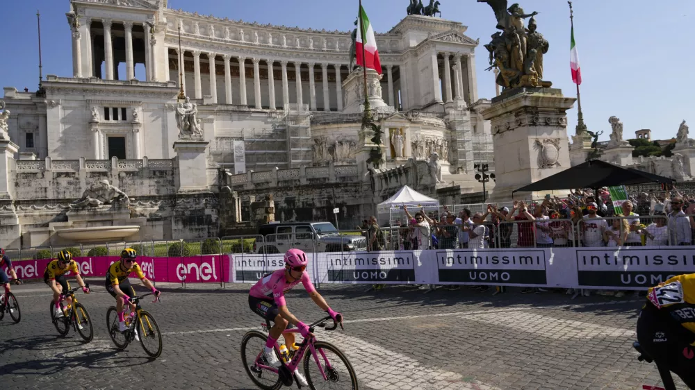 Primoz Roglic of Slovenia wears the overall leader's pink jersey as he rides past the Unknown Soldier monument during the 21st and last stage of the Giro D'Italia, tour of Italy cycling race, in Sunday, May 28, 2023. (AP Photo/Alessandra Tarantino)