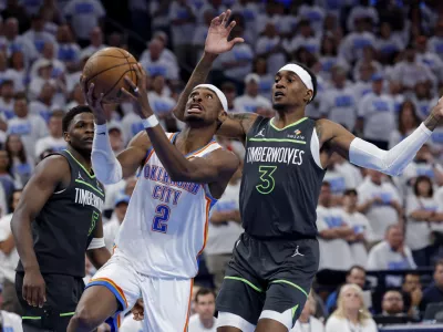 May 20, 2025; Oklahoma City, Oklahoma, USA; Oklahoma City Thunder guard Shai Gilgeous-Alexander (2) drives against Minnesota Timberwolves forward Jaden McDaniels (3) in the fourth quarter during game one of the western conference finals for the 2025 NBA Playoffs at Paycom Center. Mandatory Credit: Alonzo Adams-Imagn Images