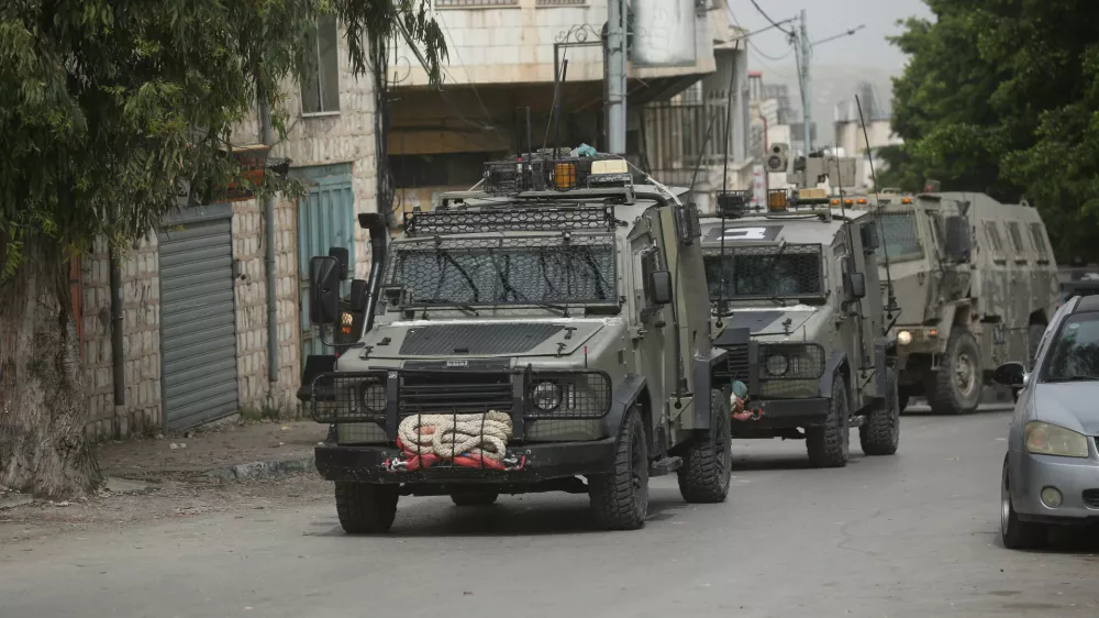 08 April 2025, Palestinian Territories, Nablus: Israeli army armoured vehicles moves along a road during a military operation in Nablus in the occupied West Bank. Photo: Mohammed Nasser/APA Images via ZUMA Press Wire/dpa
