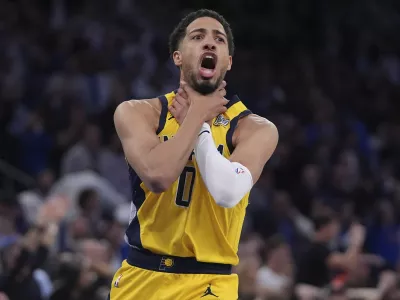 Indiana Pacers guard Tyrese Haliburton (0) makes a choke motion towards the New York Knicks after hitting a shot at the end of the fourth quarter of Game 1 of the NBA basketball Eastern Conference final, Wednesday, May 21, 2025, in New York. (AP Photo/Frank Franklin II)
