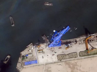A satellite image shows a North Korean warship covered with a blue tarp after an accident that occurred during its launch at the shipyard in Chongjin, North Korea, May 23, 2025. 2025 Planet Labs PBC/Handout via REUTERS THIS IMAGE HAS BEEN SUPPLIED BY A THIRD PARTY. MANDATORY CREDIT