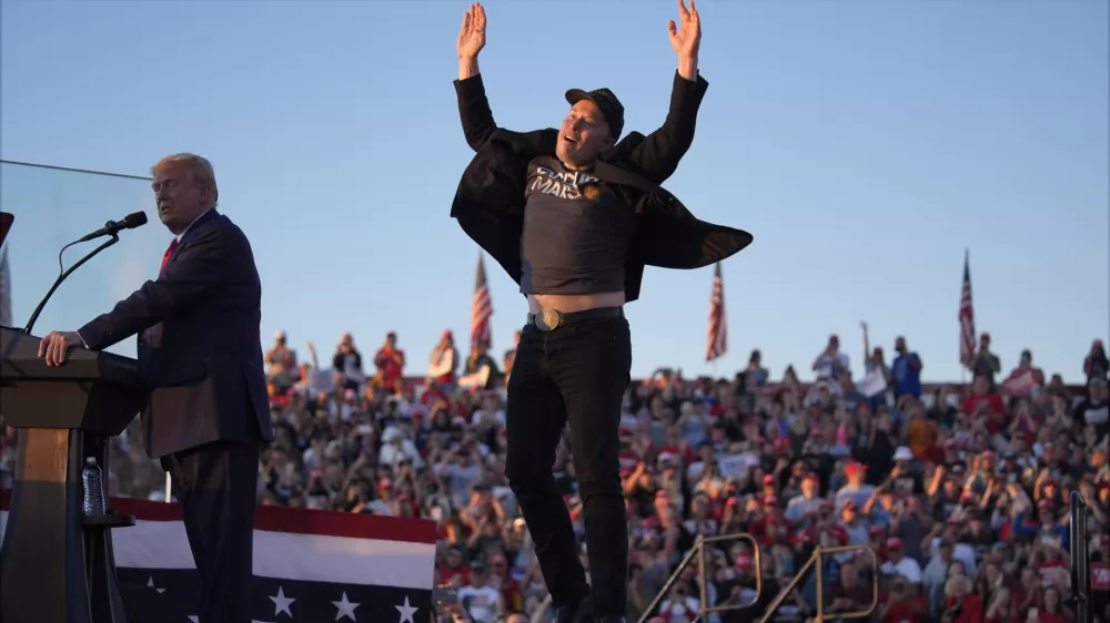 FILE - Elon Musk jumps on the stage as Republican presidential nominee former President Donald Trump speaks at a campaign rally at the Butler Farm Show, Oct. 5, 2024, in Butler, Pa. (AP Photo/Evan Vucci, File)
