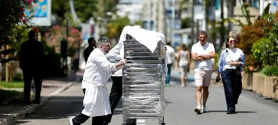 Cooks bring out the food from the Carlton Hotel Beach Club on the Croisette following a major electricity outage, during the 78th Cannes Film Festival in Cannes, May 24, 2025. REUTERS/Benoit Tessier