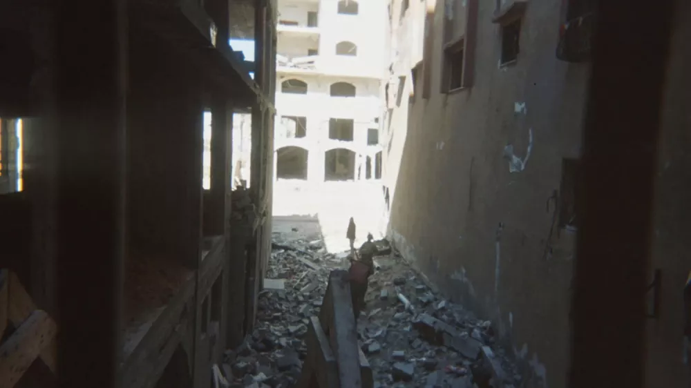 This photo provided by Breaking the Silence, a whistleblower group of former Israeli soldiers, shows two soldiers behind Palestinian detainees being sent into a Gaza City-area house to clear it in 2024. (Breaking the Silence via AP)