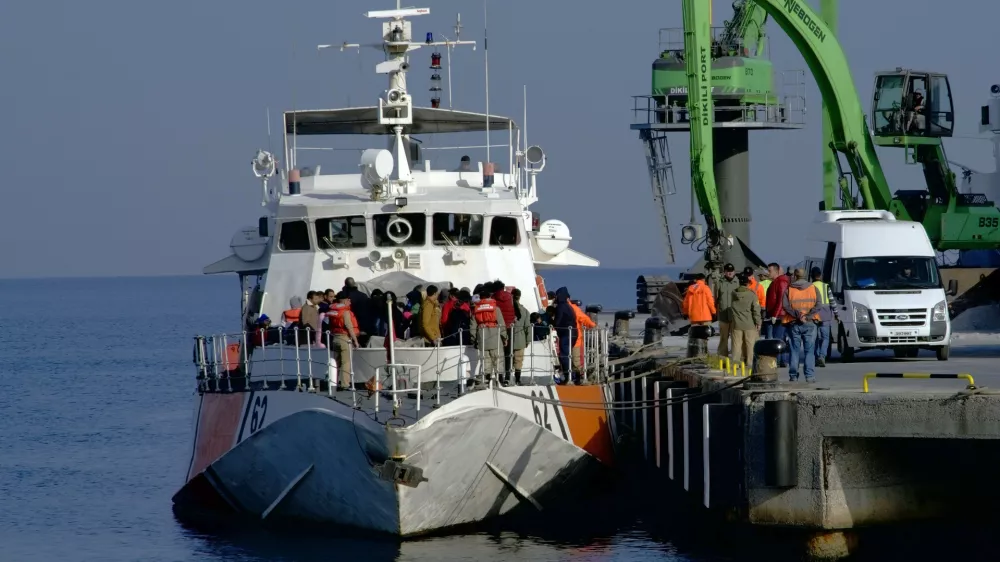 Migrants disembark after they were apprehended by the Turkish coast guard on the Aegean Sea between Turkey and Greece, in Dikili port, Turkey, Wednesday, April 6, 2016. The group of some 60 people were brought to a coast guard station in the western province of Izmir. The European Union began sending back migrants this week under a deal with Turkey aimed at preventing the flow of migrant to Europe.(AP Photo/Mehmet Guzel)