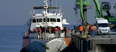 Migrants disembark after they were apprehended by the Turkish coast guard on the Aegean Sea between Turkey and Greece, in Dikili port, Turkey, Wednesday, April 6, 2016. The group of some 60 people were brought to a coast guard station in the western province of Izmir. The European Union began sending back migrants this week under a deal with Turkey aimed at preventing the flow of migrant to Europe.(AP Photo/Mehmet Guzel)