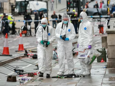 Forensic officers work near the site of an incident where a car plowed into a crowd of Liverpool fans during a parade celebrating their side's Premier League soccer title, in central Liverpool, Britain, May 27, 2025. REUTERS/Phil Noble