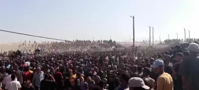 Palestinians rush to get aid boxes, in Rafah, in the southern Gaza Strip, May 27, 2025, in this screengrab from a video. Reuters TV/via REUTERS