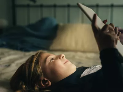 Sweet blondie girl playing on a Tablet PC.