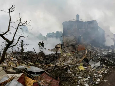 Emergency workers extinguish fire in the debris of a private house that was destroyed in a Russian rocket strike, amid Russia's attack on Ukraine, in Markhalivka, Kyiv region, Ukraine, May 25, 2025. REUTERS/Thomas Peter