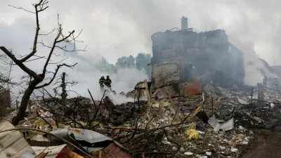 Emergency workers extinguish fire in the debris of a private house that was destroyed in a Russian rocket strike, amid Russia's attack on Ukraine, in Markhalivka, Kyiv region, Ukraine, May 25, 2025. REUTERS/Thomas Peter