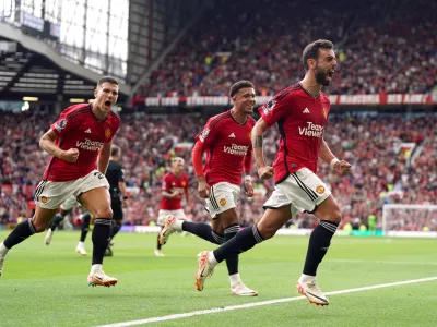 26 August 2023, United Kingdom, Manchester: Manchester United's Bruno Fernandes (R) celebrates scoring his side's third goal with teammate during the English Premier League soccer match between Manchester United and Nottingham Forest at Old Trafford. Photo: Nick Potts/PA Wire/dpa