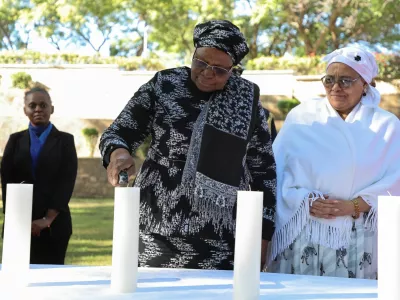 Namibia's first female President, Netumbo Nandi-Ndaitwah, and Vice President Lucia Witbooi, light a ceremonial candle as the country holds its first commemoration for victims of the Herero and Nama genocide, massacred by German colonial forces more than a century ago, in the capital, Windhoek, Namibia, May 28, 2025. REUTERS/Stringer