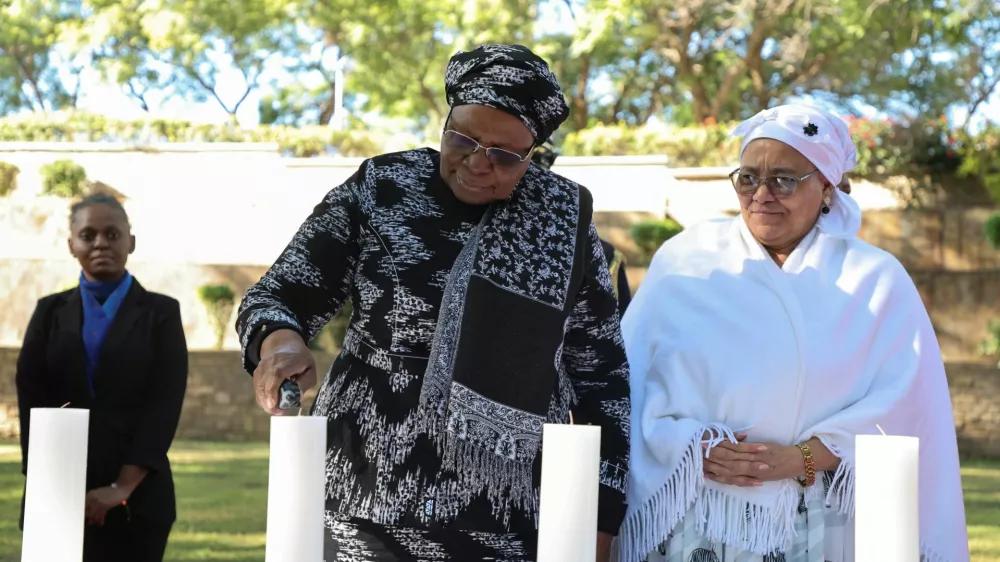 Namibia's first female President, Netumbo Nandi-Ndaitwah, and Vice President Lucia Witbooi, light a ceremonial candle as the country holds its first commemoration for victims of the Herero and Nama genocide, massacred by German colonial forces more than a century ago, in the capital, Windhoek, Namibia, May 28, 2025. REUTERS/Stringer