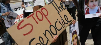 Protestors hold pictures of Palestinian children killed in Gaza during a demonstration organized by Israeli citizens demanding action from the European Union against the government of Israel to stop the war, outside the Portuguese parliament in Lisbon, Tuesday, May 27, 2025. (AP Photo/Armando Franca)