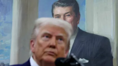 A portrait of former U.S. President Ronald Reagan hangs behind U.S. President Donald Trump as he answers questions from members of the news media in the Oval Office at the White House in Washington, D.C., U.S., May 28, 2025. REUTERS/Leah Millis