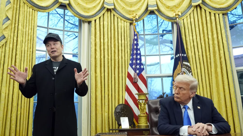 FILE - President Donald Trump listens as Elon Musk speaks in the Oval Office at the White House, Feb. 11, 2025, in Washington. (AP Photo/Alex Brandon, File)