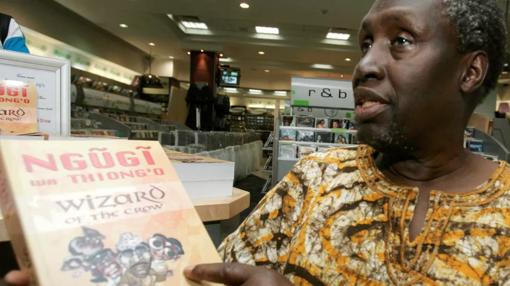 FILE PHOTO: Kenyan author Ngugi Wa Thiong'o shows his newly launched book "Wizard of the Crow" during an interview with Reuters at a bookshop in downtown Nairobi January 16, 2007. The book, which took Wa Thiong'o more than six years to write, was released on Monday, about 20 years after his novel "Matigari". REUTERS/Antony Njuguna/File Photo