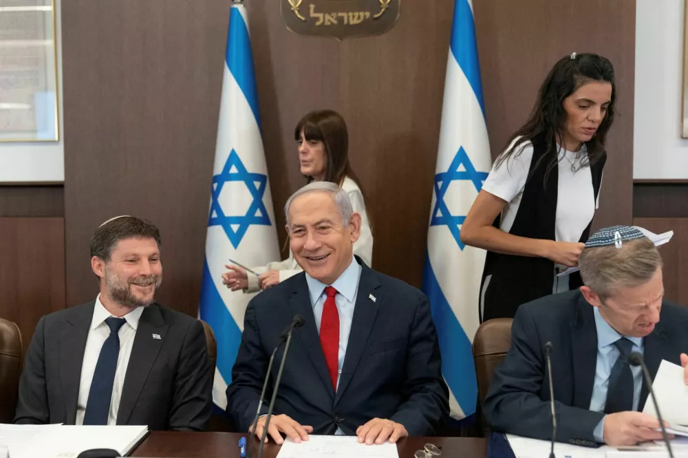Israeli Prime Minister Benjamin Netanyahu, centre, and Finance Minister Bezalel Smotrich, left, attend a weekly cabinet meeting in the prime minister's office in Jerusalem, June 18, 2023. Ohad Zwigenberg/Pool via REUTERS