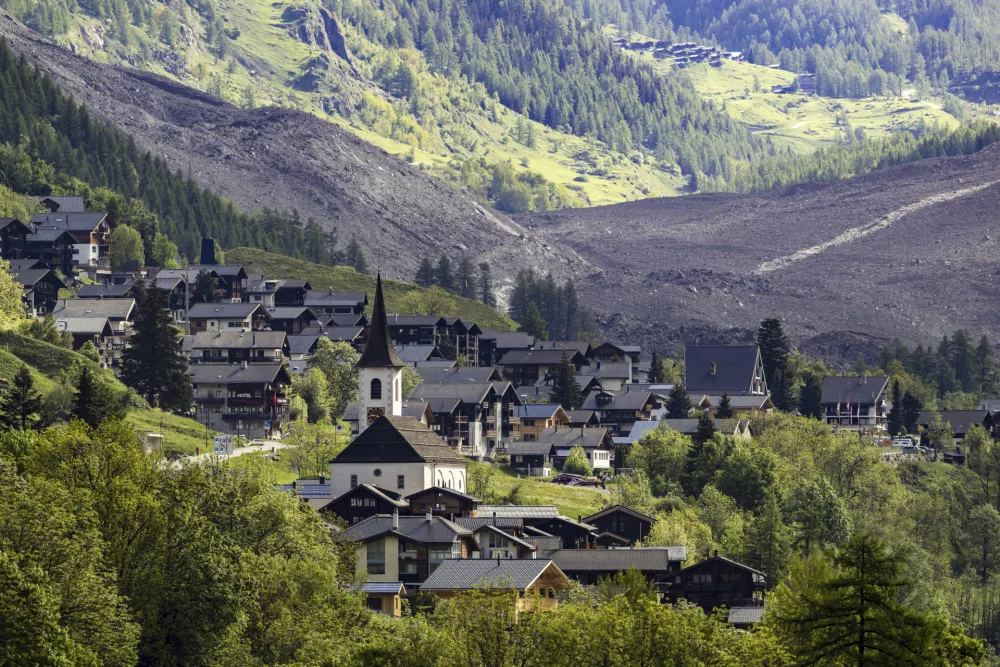 A massive debris avalanche, with the village of Kippel in the foreground, is seen on Thursday, May 29, 2025, one day after the collapse of the Birch Glacier causing the demolishing of the village of Blatten in Switzerland. (Jean-Christophe Bott/Keystone via AP)