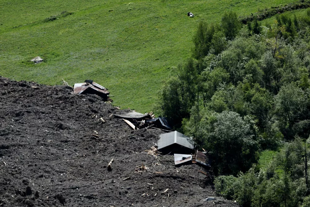 Debris and dust from a crumbling glacier that partially collapsed and tumbled onto the village of Blatten, Switzerland is seen on May 29, 2025. REUTERS/Stefan Wermuth