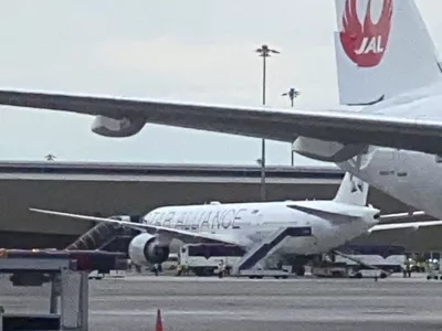 The Boeing 777-300ER aircraft of Singapore Airlines, flight SQ321 from Heathrow is seen on tarmac after requesting an emergency landing at Bangkok's Suvarnabhumi International airport, Thailand, Tuesday, May 21, 2024. One person has died aboard a London-Singapore flight that encountered severe turbulence, Singapore Airlines said Tuesday, in which the plane apparently plummeted for a number of minutes before it was diverted to Bangkok, where emergency crews rushed to help injured passengers amid stormy weather. (Pongsakorn Rodphai via AP)