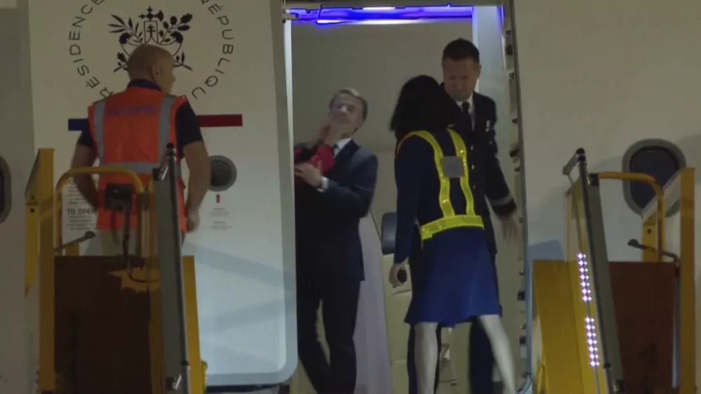 In this grab taken from video, France's President Emmanuel Macron prepares to disembark a plane on arrival, in Hanoi, Vietnam, Sunday, May 25, 2025. (AP Photo/Hau Dinh)