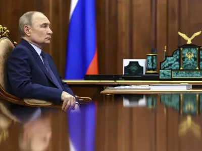 Russian President Vladimir Putin listens to Archpriest Alexander Tkachenko, Chairman of the Board of the Circle of Kindness Foundation and head of the commission for social partnership, trusteeship, and inclusive practices at the Russian Civic Chamber, at the Kremlin in Moscow, on Friday, May 30, 2025. (Alexander Kazakov, Sputnik, Kremlin Pool Photo via AP)