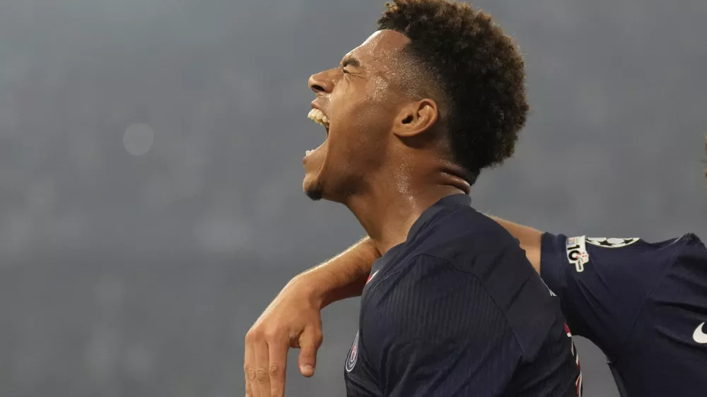 PSG's Desire Doue celebrates after scoring his side's second goal against Inter Milan during the Champions League final soccer match at the Allianz Arena in Munich, Germany, May 31, 2025. (AP Photo/Matthias Schrader)