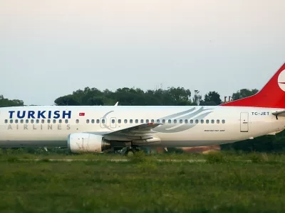 REFILE - ADDITIONAL INFORMATIONA hijacked Turkish Airlines plane sits on the runway at the Brindisi airport October 3, 2006. Two Turkish hijackers seeking to send a message to Pope Benedict seized a Turkish passenger plane flying from the Albanian capital Tirana to Istanbul on Tuesday and diverted it to Italy. REUTERS/Fabio Serino (ITALY)