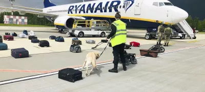 FILE - In this May 23, 2021, file photo provided by ONLINER.BY, security use a dog to check the luggage of passengers on the Ryanair jet that carried opposition figure Raman Pratasevich, traveling from Athens to Vilnius, Lithuania. The plane was diverted to Minsk, Belarus, after Belarusian flight controllers told the crew that there was a bomb threat against the plane. Pratasevich, who ran a channel on a messaging app used to organize demonstrations against authoritarian President Alexander Lukashenko, left his homeland in 2019 to try to escape the reach of the Belarusian KGB. Pratasevich was arrested upon landing in Minsk and faces 15 years in prison on charges of inciting disturbances. ď»żď»ż(ONLINER.BY via AP)
