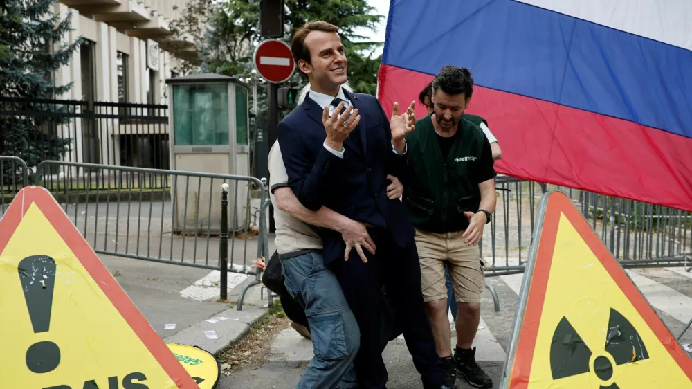 Greenpeace activists install a wax statue of French President Emmanuel Macron borrowed from the Grevin Museum without permission, to denounce what they call France's continued commercials ties with Russia despite the war in Ukraine, in front of the Russian Embassy in Paris, France, June 2, 2025. REUTERS/Benoit Tessier