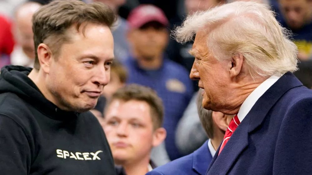 FILE PHOTO: Elon Musk greets U.S. President Donald Trump as they attend the NCAA men's wrestling championships in Philadelphia, Pennsylvania, U.S., March 22, 2025. REUTERS/Nathan Howard/File Photo