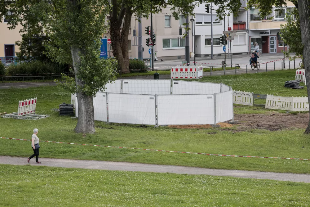 One of the three unexploded bombs from the Second World War is fenced off with screens as specialists prepare to defuse them in Cologne, Tuesday, June 3, 2025. (Thomas Banneyer/dpa via AP)