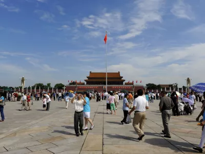 Visitors gather in Tiananmen Square in Beijing, Friday, Aug. 15, 2008. Pollution concerns evaporated Friday under a picture-perfect canopy of blue skies and white clouds on the first day of the Olympic Games' signature track-and-field events. (AP Photo/Oliver Multhaup)