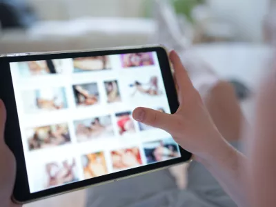 FILED - 14 April 2025, Hamburg: A young person looks at a porn website on a smartphone. Aylo, the company behind Pornhub, Redtube and Youporn, plans to block content from the afternoon onwards in protest at new French age verification regulations, local media reports said on Tuesday. Photo: Marcus Brandt/dpa
