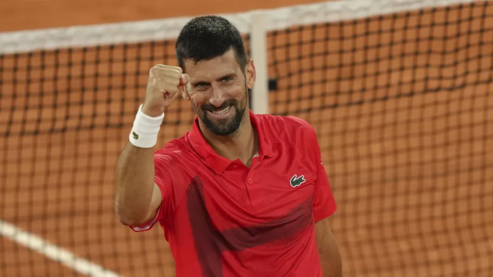 Serbia's Novak Djokovic celebrates as he won the quarterfinal match of the French Tennis Open against Germany's Alexander Zverev at the Roland-Garros stadium in Paris, Wednesday, June 4, 2025. (AP Photo/Aurelien Morissard)