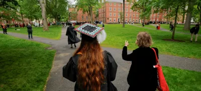 FILE PHOTO: People walk to attend the 374th Commencement exercises at Harvard University in Cambridge, Massachusetts, U.S., May 29, 2025. REUTERS/Brian Snyder/File Photo