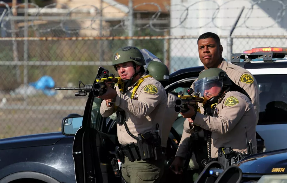 Members of law enforcement operate amidst a standoff between police and protesters following multiple detentions by Immigration and Customs Enforcement (ICE), in the Los Angeles County city of Compton, California, U.S., June 7, 2025.  REUTERS/Daniel Cole REFILE - CORRECTING LOCATION FROM "PARAMOUNT" TO "COMPTON".