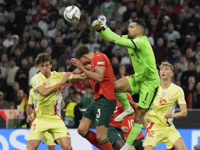 Portugal goalkeeper Diogo Costa punches out the ball during the Nations League final soccer match between Portugal and Spain at the Allianz Arena in Munich, Germany, Sunday, June 8, 2025. (AP Photo/Matthias Schrader)